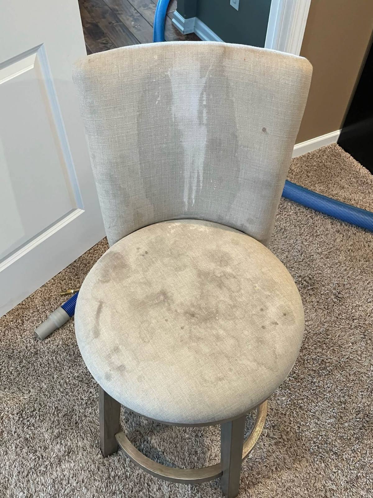 Upholstered chair before professional cleaning