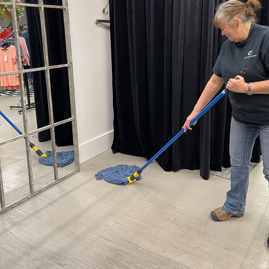 Women cleaning and moping floor.