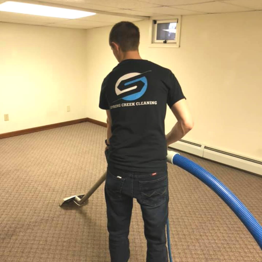 Owner Montana cleaning floor in a basement